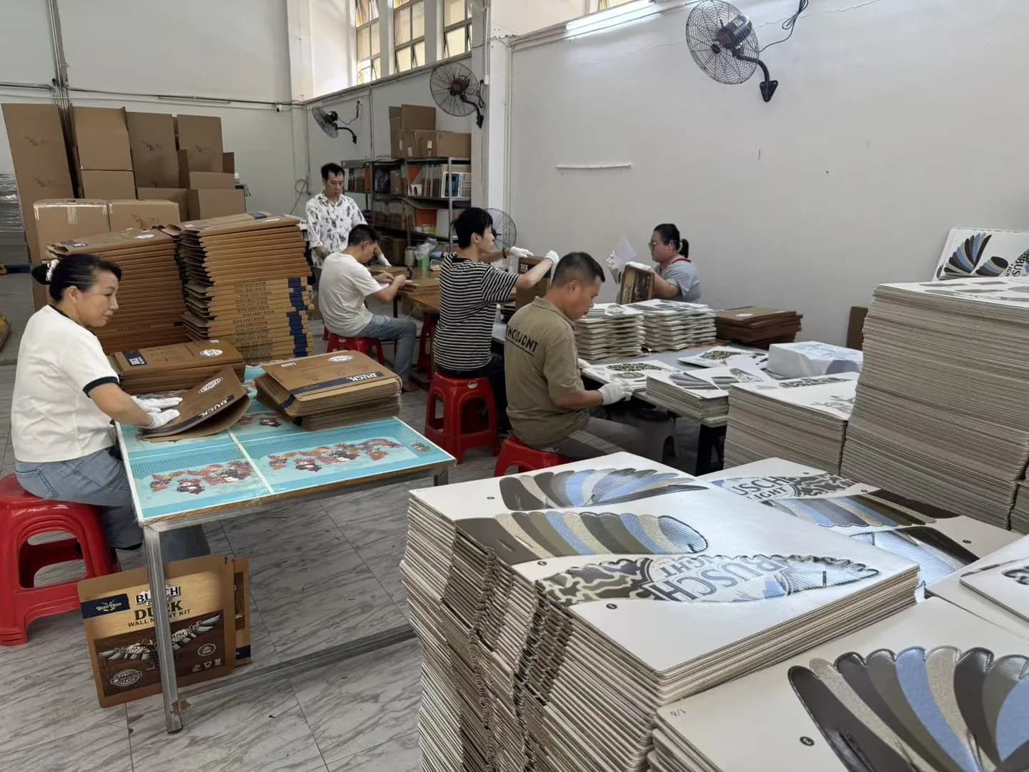 Staff handling printed products at Charmer’s own production site