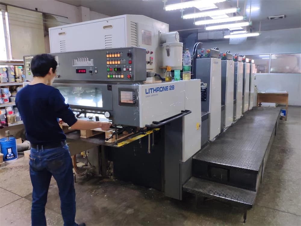Operator beside printing equipment at the Charmer production site